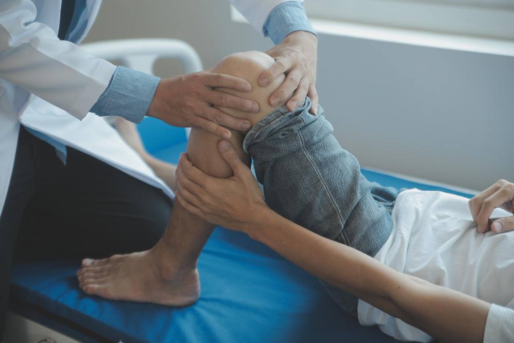 An orthopaedic specialist checking a patient.